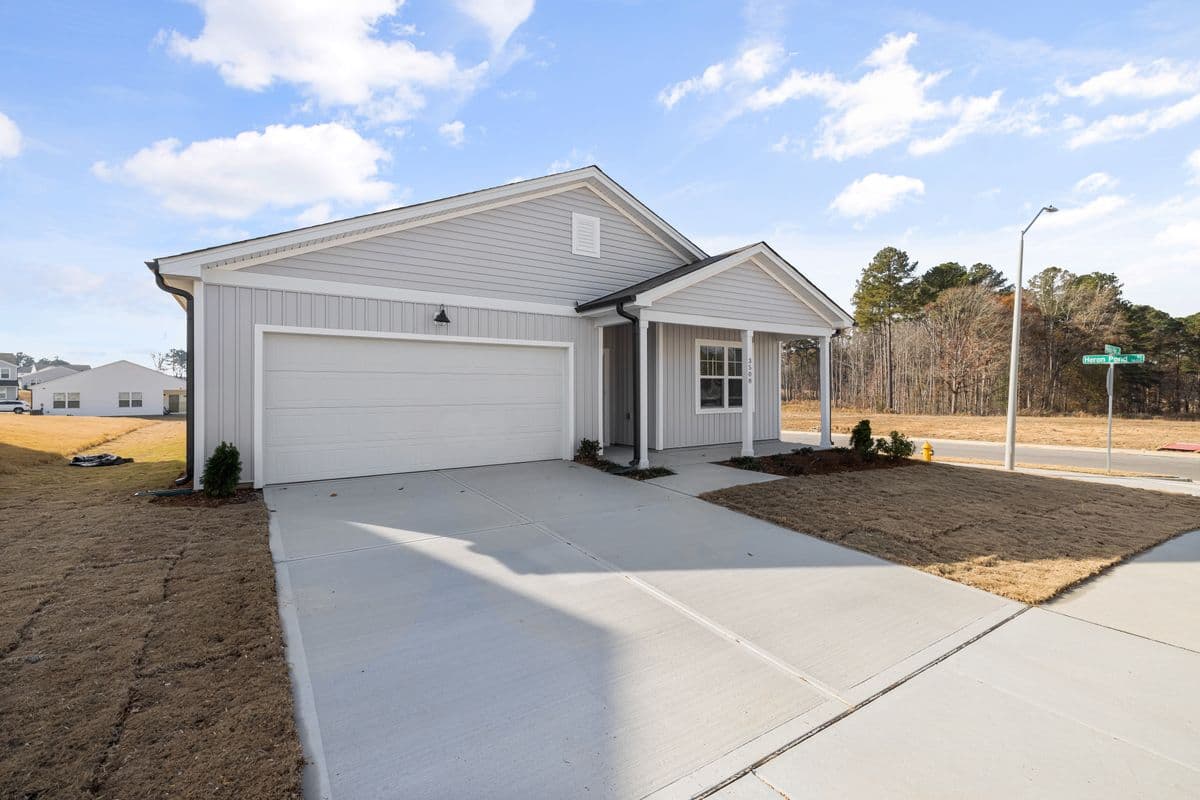 Clean concrete driveway in front of a house