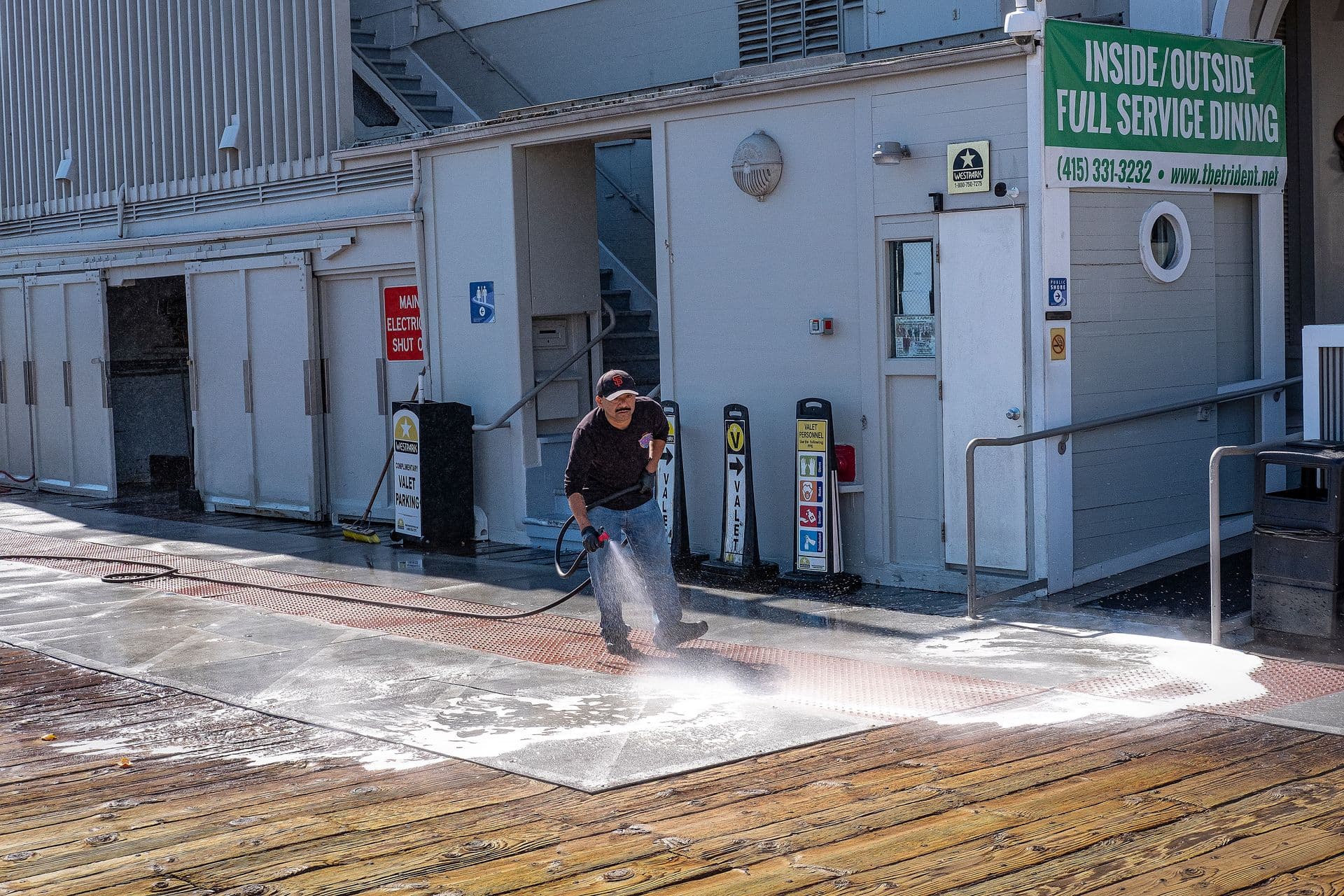 Professional pressure washing an exterior surface
